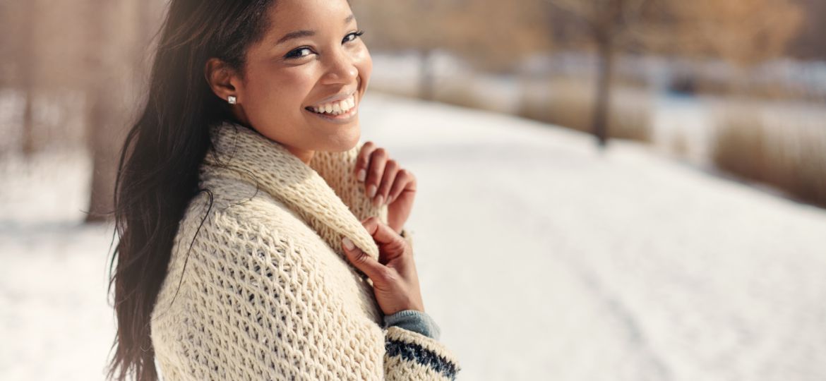 Beautiful young woman in the snow in winter