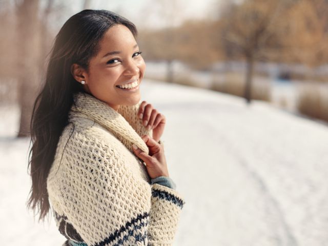 Beautiful young woman in the snow in winter